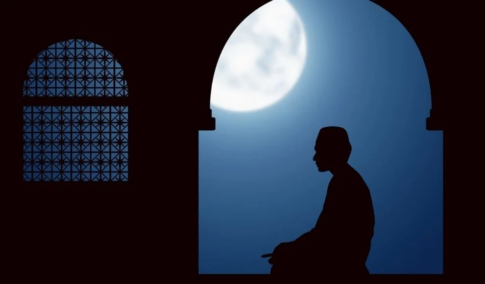 image of a person praying in the moonlight